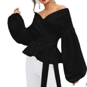 0c6cc3fb-2c68-4790-8f29-2d68369a5853jpg • Punkin's Patch Black off-the-shoulder peplum top with voluminous bishop sleeves and a waist tie, styled on a model with white pants used for contrast.