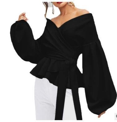 0c6cc3fb-2c68-4790-8f29-2d68369a5853jpg • Punkin's Patch Black off-the-shoulder peplum top with voluminous bishop sleeves and a waist tie, styled on a model with white pants used for contrast.
