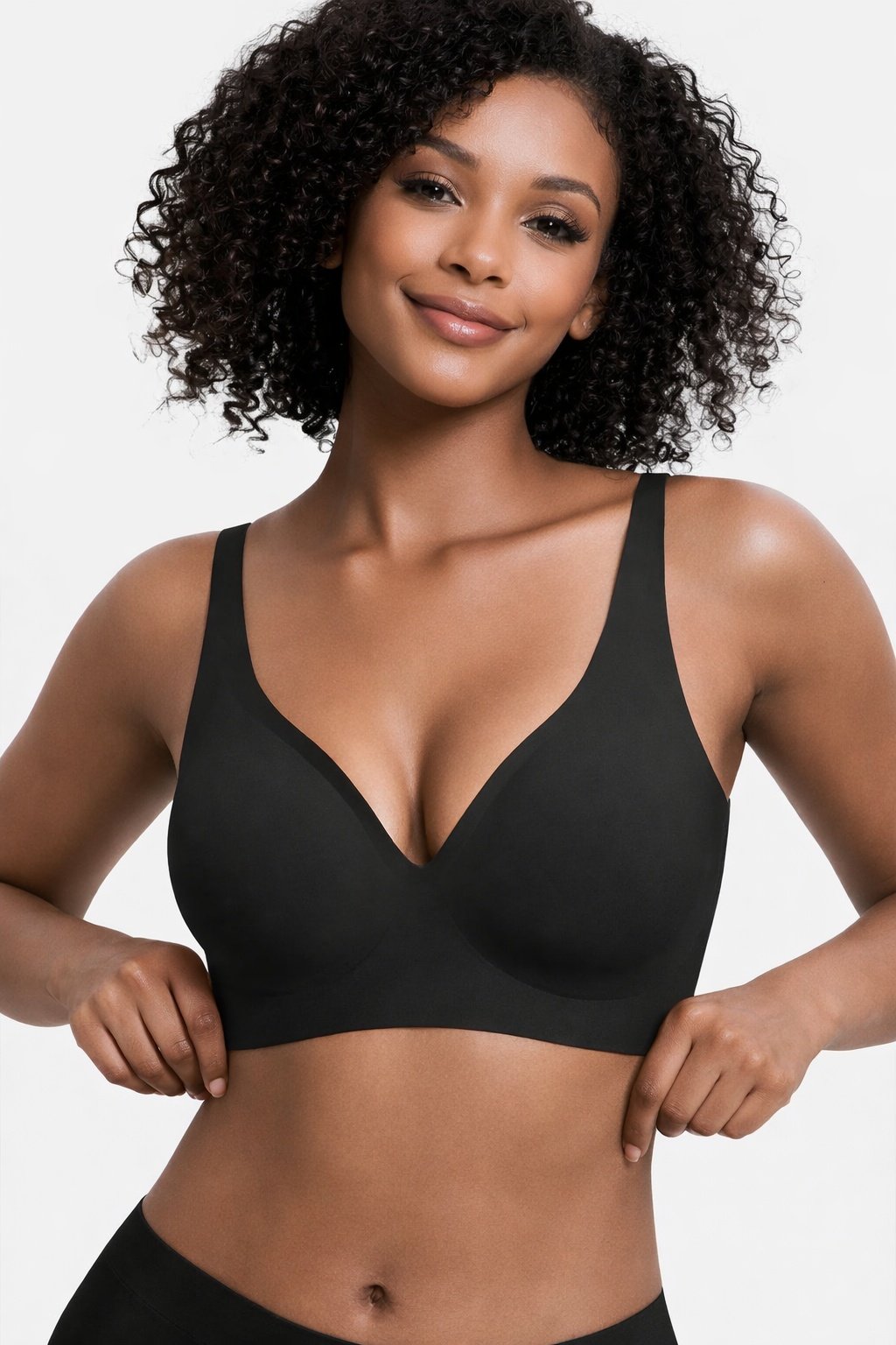 0fe594df-1a2d-440d-92c1-b415ff2ad575jpg • Punkin's Patch Smiling woman modeling a black seamless bra against a light background.