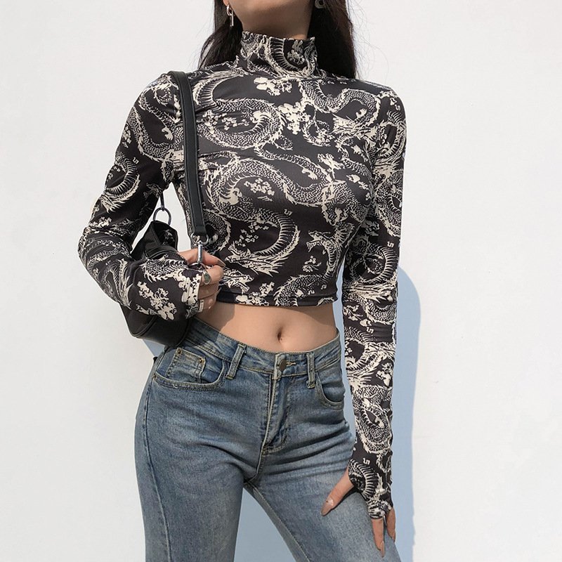 1532644246184jpg • Punkin's Patch Person wearing a black-and-white dragon-print turtleneck crop top with blue jeans and a black crossbody bag بعيد.