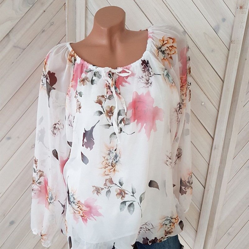 1624002717587jpg • Punkin's Patch White floral blouse with pink, peach, and blue flowers on a sheer fabric, long sleeves, gathered neckline with a tie on a mannequin.