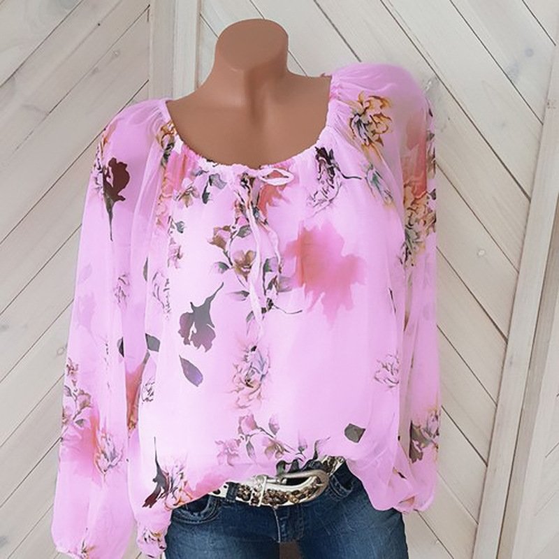 1624002717589jpg • Punkin's Patch Pink sheer floral blouse with long puff sleeves on a mannequin, paired with jeans and a belt.