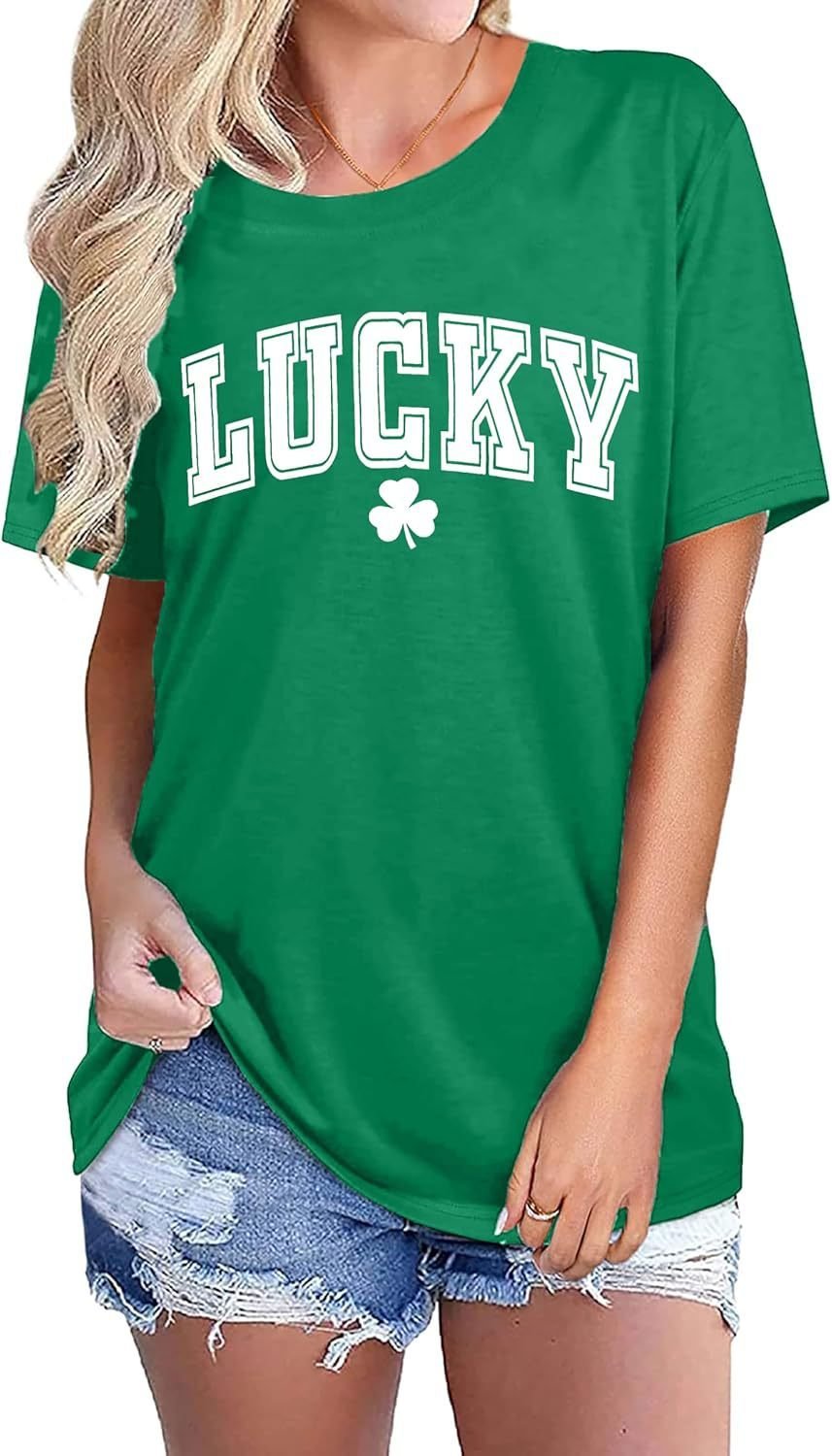 2104ec53-d98d-42e2-834d-aa0d10c4f84djpg • Punkin's Patch Green T-shirt with 'LUCKY' text and shamrock design, worn with distressed denim shorts by a model.