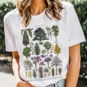 27db0dcc-611a-4b72-81e0-6b041c6b7ecdjpg • Punkin's Patch Woman wearing a white T-shirt with a large vintage botanical illustration featuring various trees and plants.