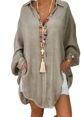 2867895205995jpg • Punkin's Patch Person wearing a loose beige linen shirt dress with rolled cuffs, hands in pockets, accessorized with colorful beaded necklaces and a tassel pendant.
