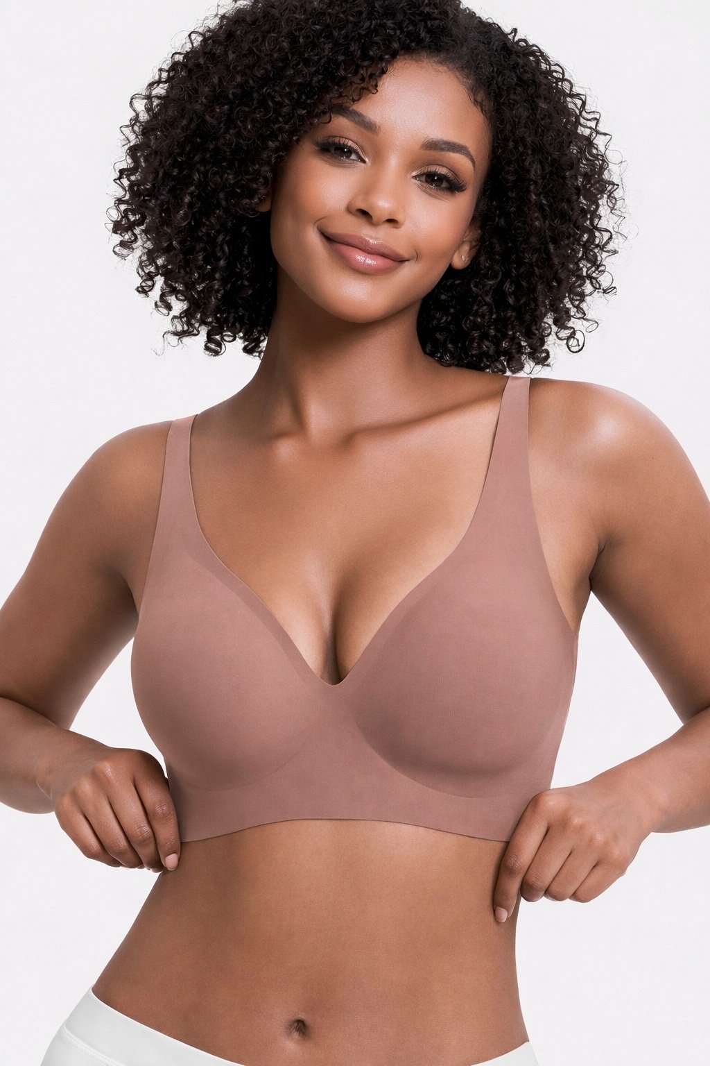 345ab52e-efab-4272-940a-5a62e151a246jpg • Punkin's Patch Smiling woman in a nude seamless bra, hands at her hips, against a light background.