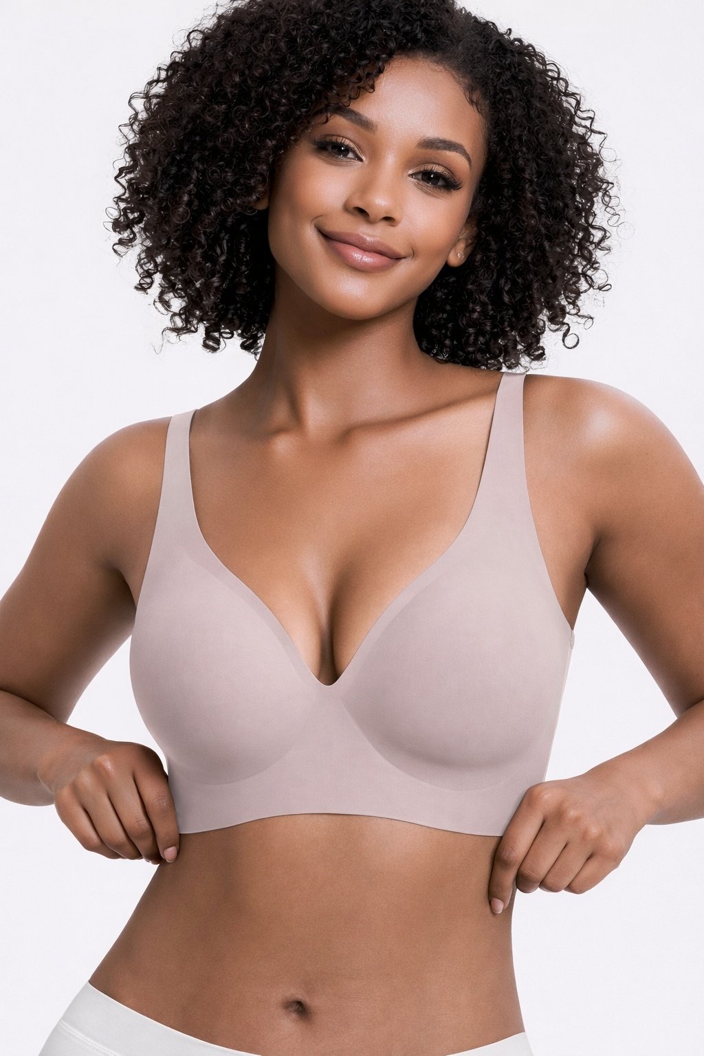 440c08d9-a0d9-49f2-b22b-6da93b1d2dc6jpg • Punkin's Patch Smiling woman wearing a beige seamless bra, posing with hands at the band.
