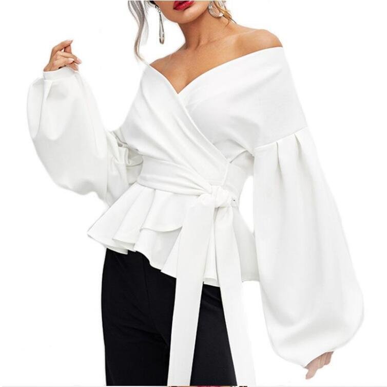 56cb1579-587c-42c9-8dd2-5e0e941d3a0ejpg • Punkin's Patch White wrap blouse with off-the-shoulder neckline, voluminous puff sleeves, and a waist tie, paired with black pants.