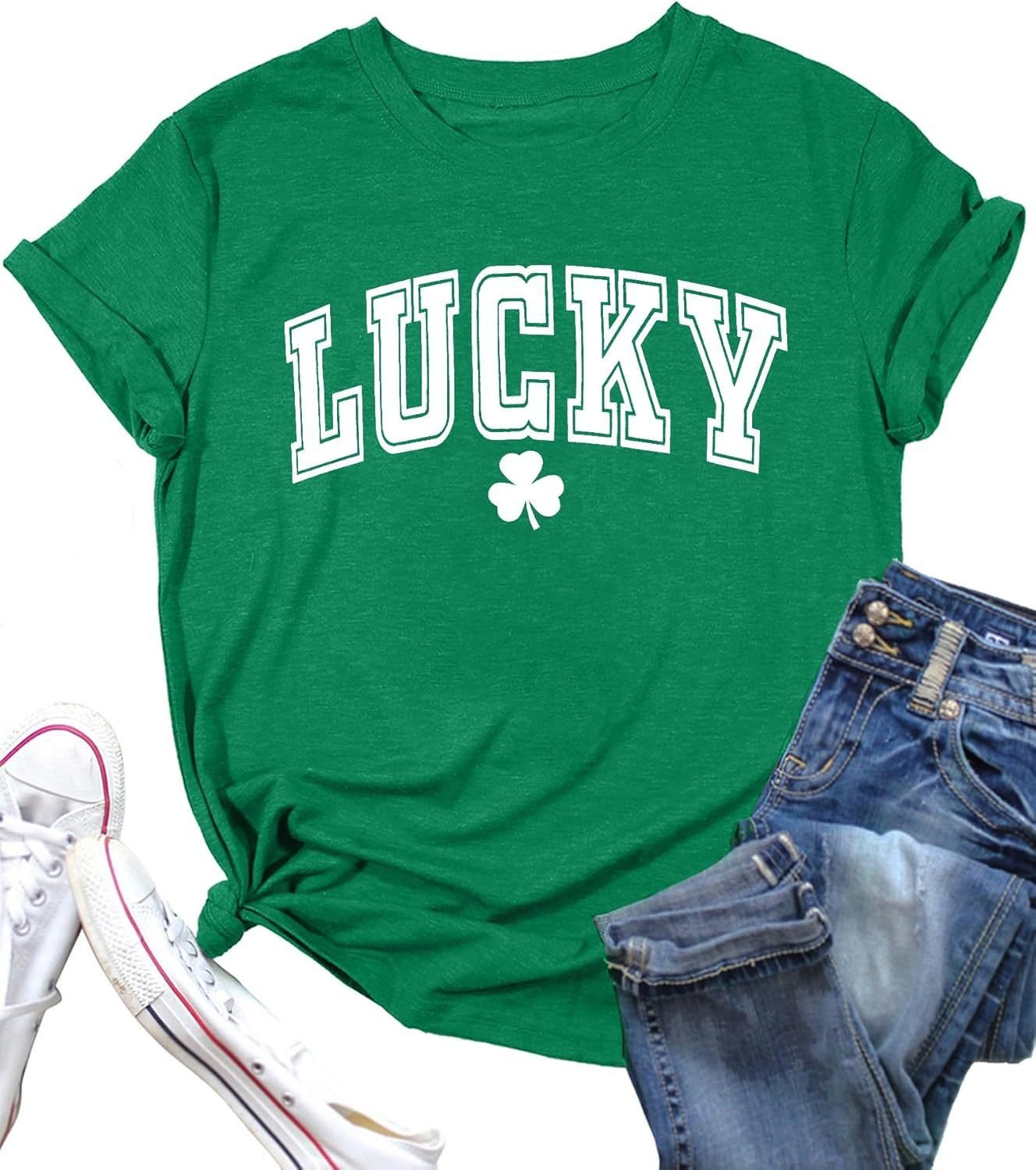 74acd748-ab84-4549-ab98-2f03a89fc925jpg • Punkin's Patch Green T-shirt with the word 'LUCKY' in white block letters and a white shamrock underneath, paired with denim jeans and white sneakers nearby.