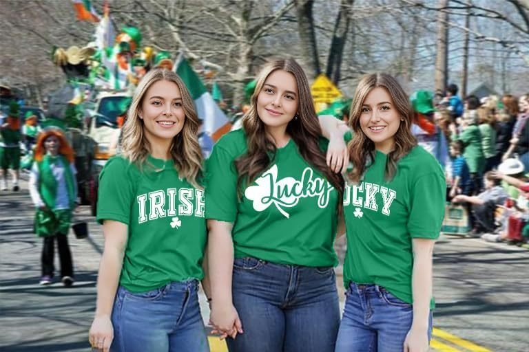 911c4cc2-9c5d-4ae4-8d02-afc3ae8d8e0fjpg • Punkin's Patch Three young women in green Irish-themed shirts posing together at a parade.