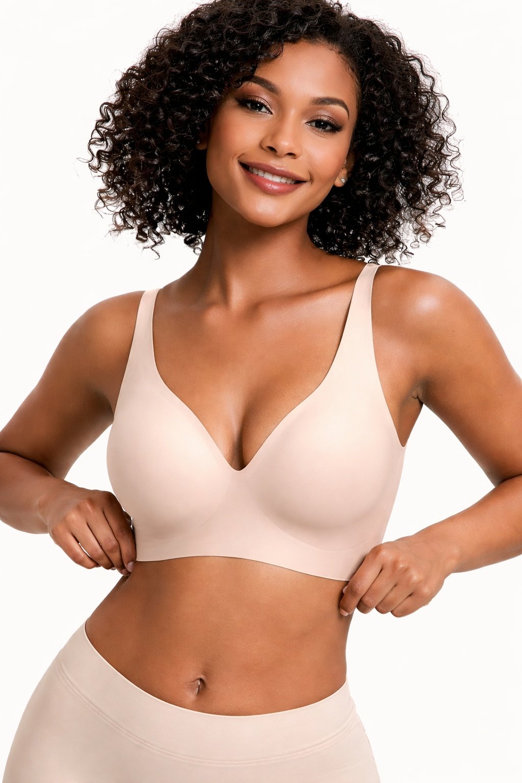 9c04b6d3-38ea-4670-964c-56e9d7d4402djpg • Punkin's Patch Woman modeling a nude-beige bra and matching seamless underwear, smiling with hands on hips in a studio.