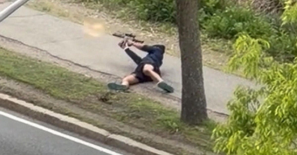 wp-header-logo-699png • Punkin's Patch Person lying on a sidewalk next to a tree after a fall, holding a skateboard overhead?