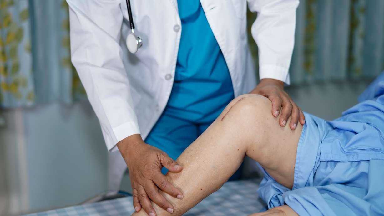 wp-header-logo-712png • Punkin's Patch Doctor examines a patient's bent knee while the patient lies on a hospital bed.