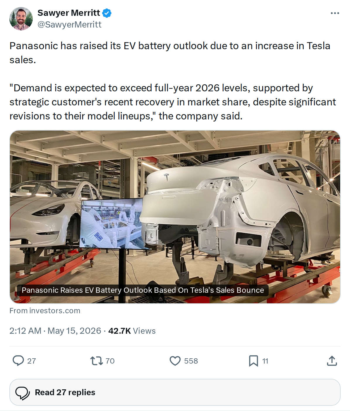 wp-header-logo-931png • Punkin's Patch Inside an automotive assembly plant, white Tesla car bodies are mounted on red rails awaiting final assembly, with a monitor displaying a production image nearby.